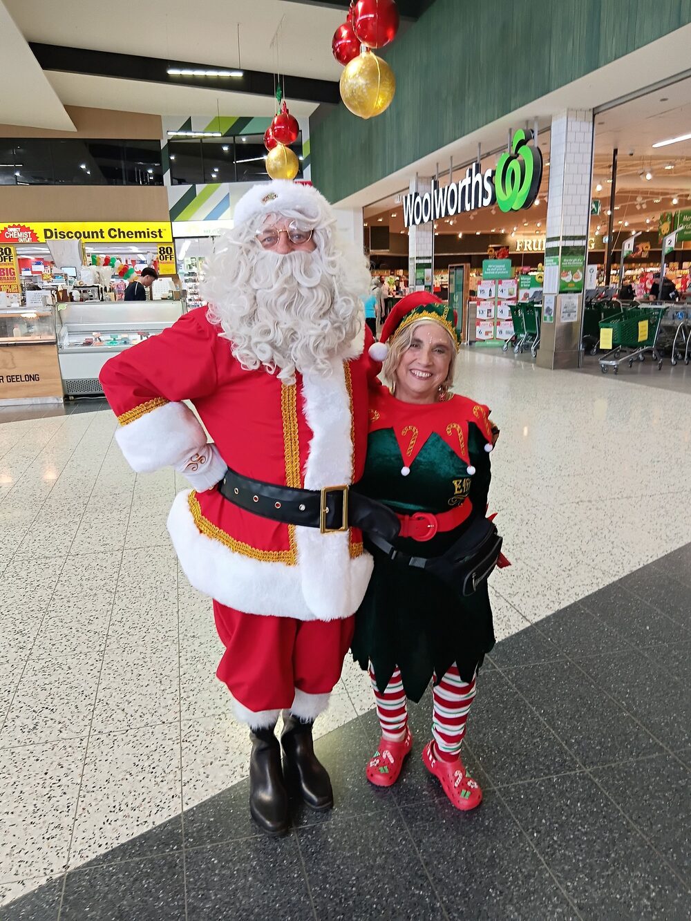 Santa and elf spreading Christmas cheer at a shopping centre