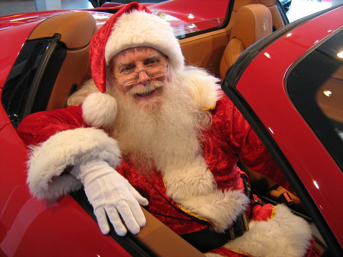 Santa Claus behind the wheel of a Ferrari