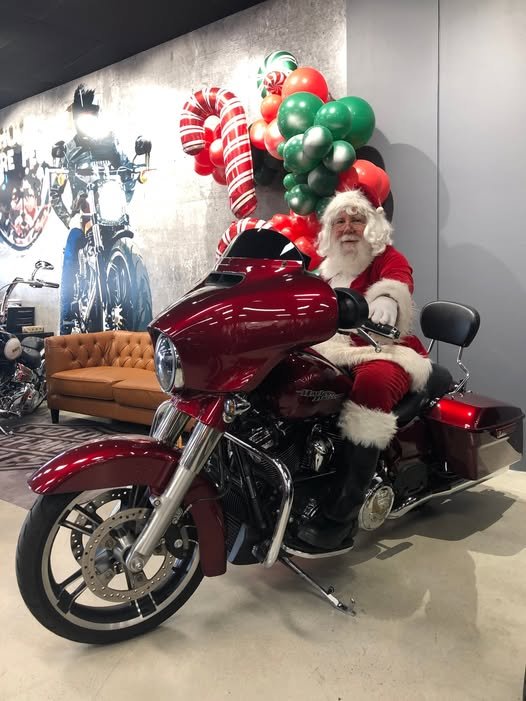 Santa arriving on a Harley-Davidson motorbike