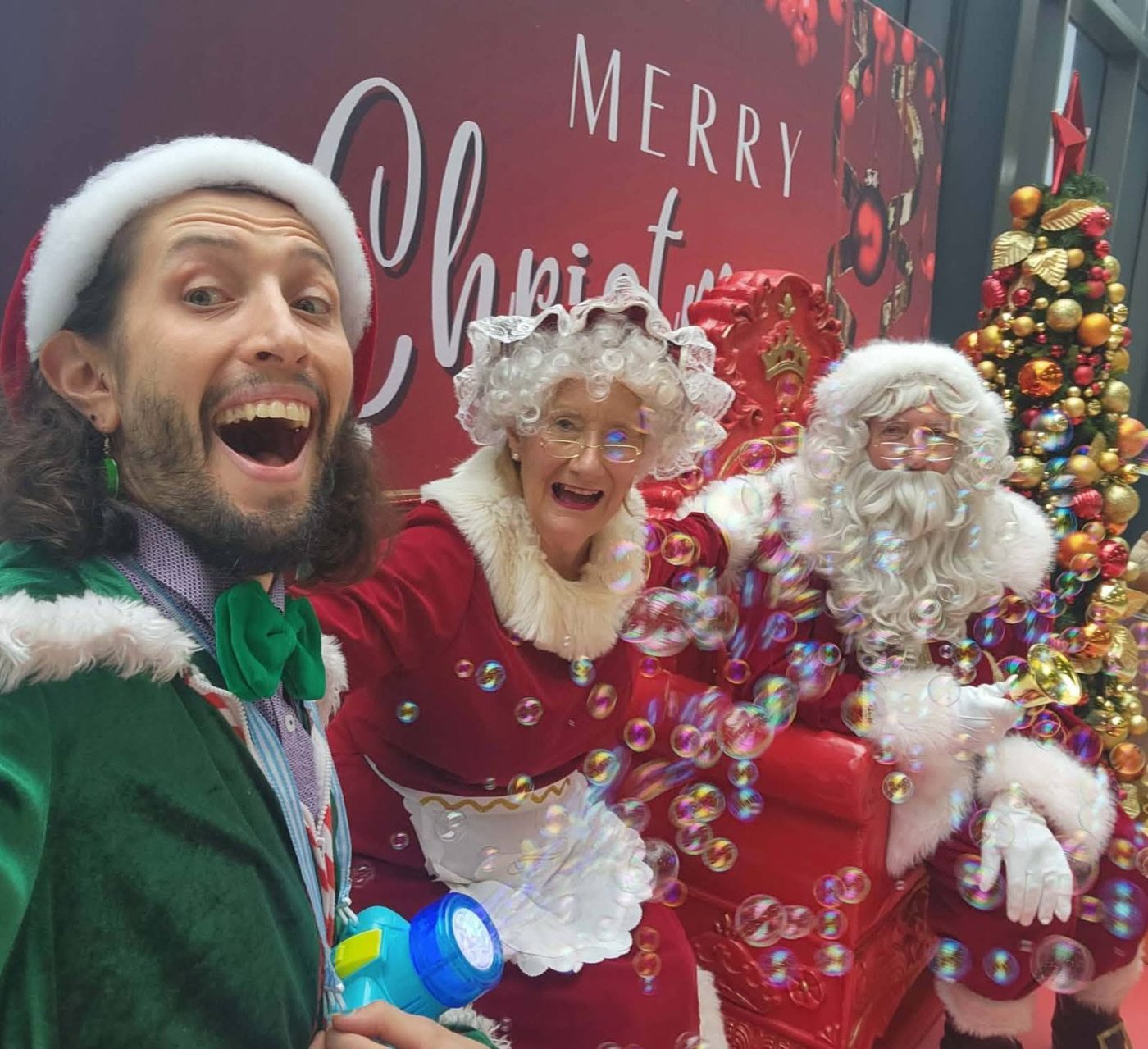 Santa, Mrs Claus and an elf performing together on stage