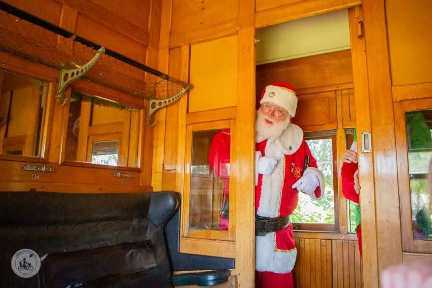 Santa peeking out of a vintage heritage train carriage