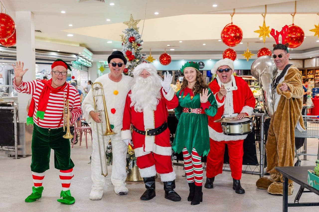 Santas, elves and a band performing at a shopping centre